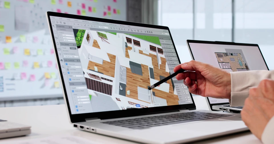 Deux déménageurs professionnels en uniformes rouge et noir emballent et organisent des biens dans un salon moderne